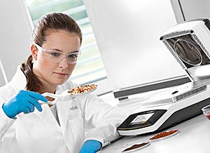 Lab operator using the MA160 IR Moisture Meter by Sartorius in thermal analysis of samples